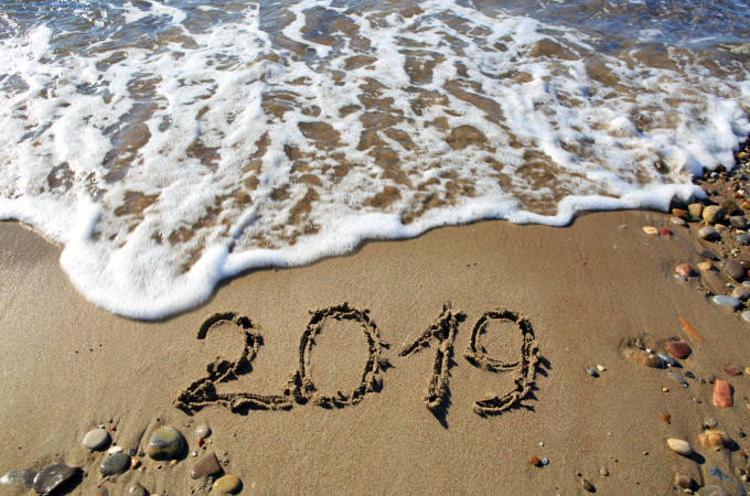 New year 2019 written in sand.