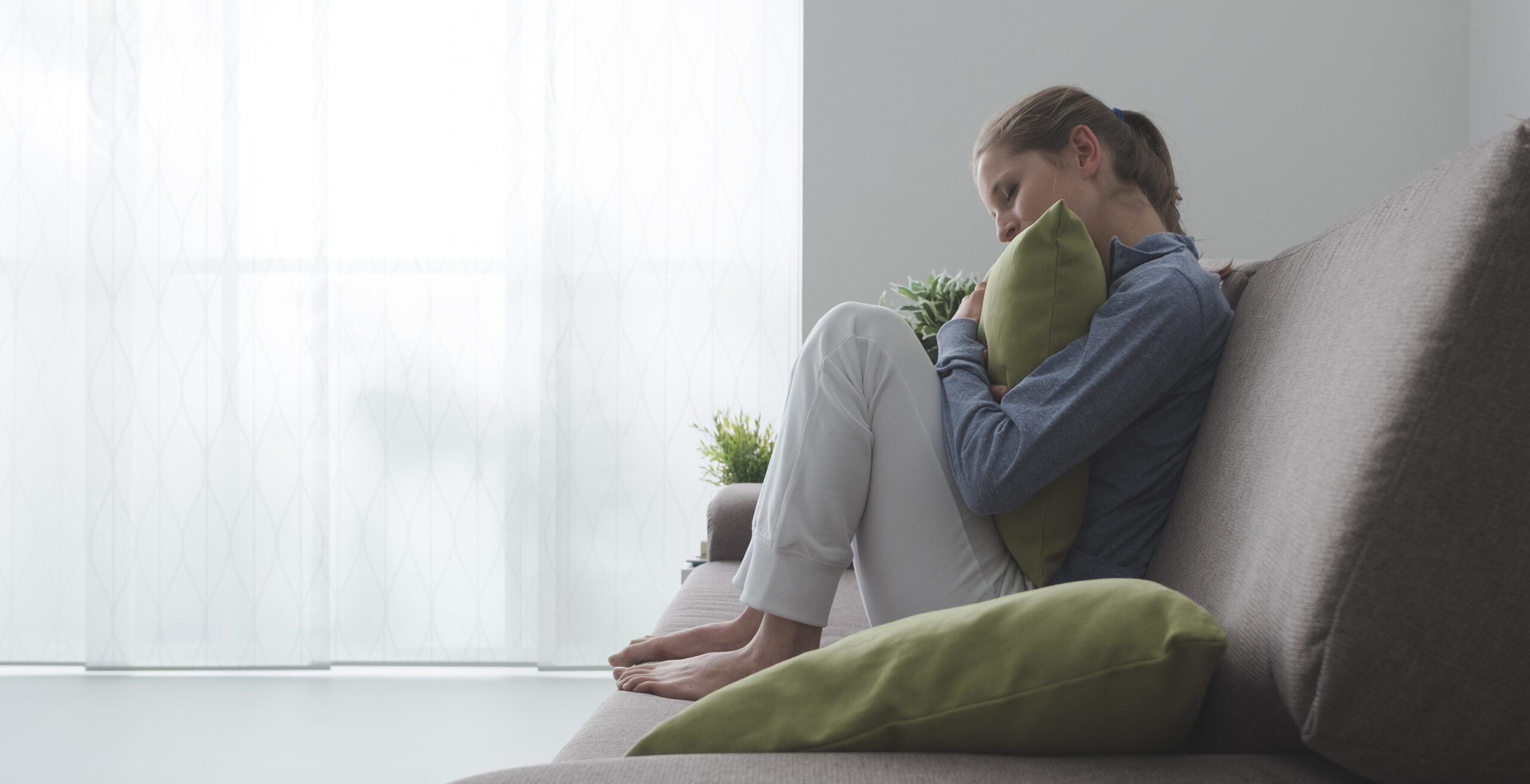 Woman Hugging a Pillow Cropped