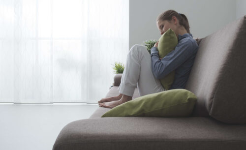 Woman Hugging a Pillow Image