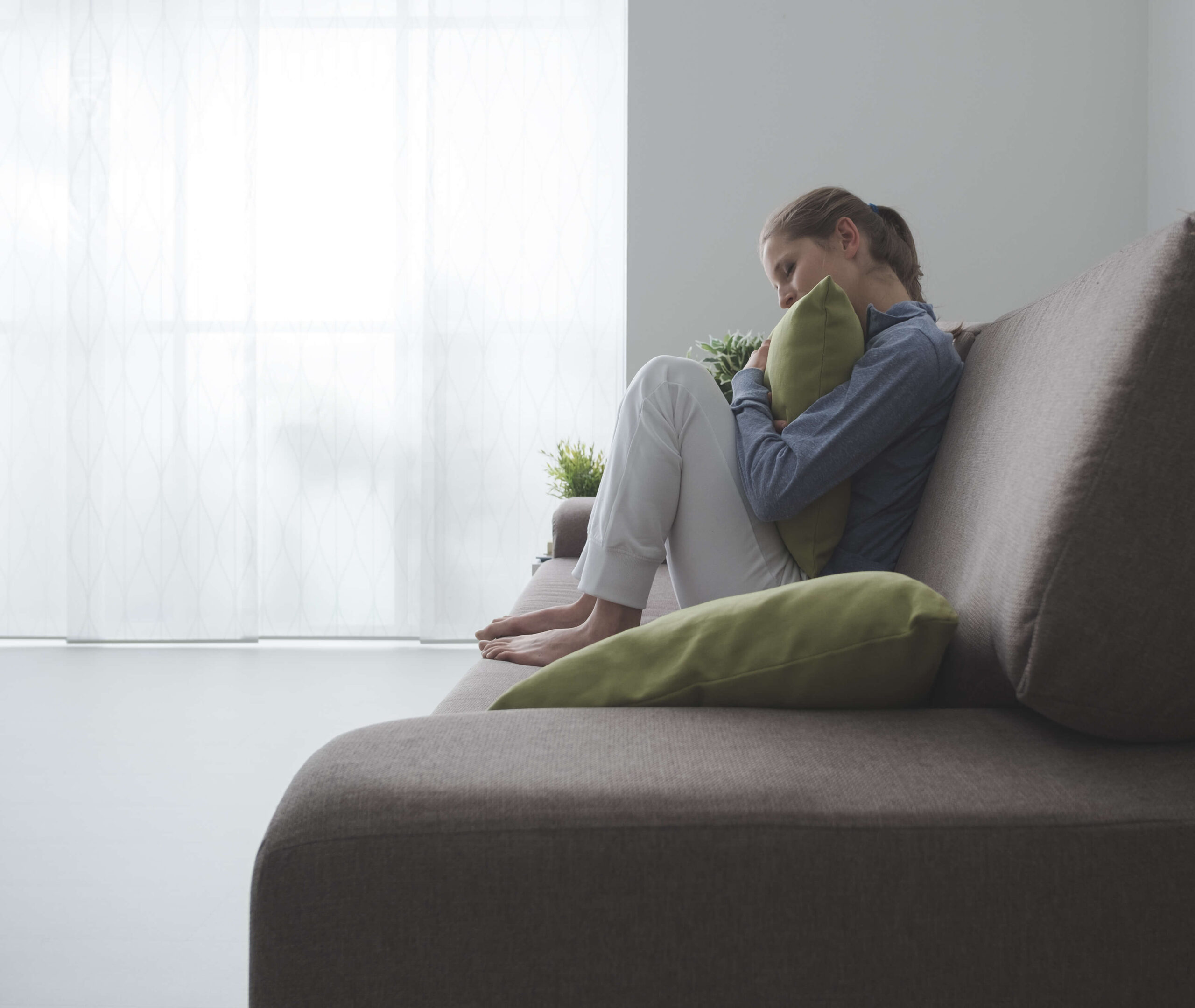 Woman Hugging a Pillow Image